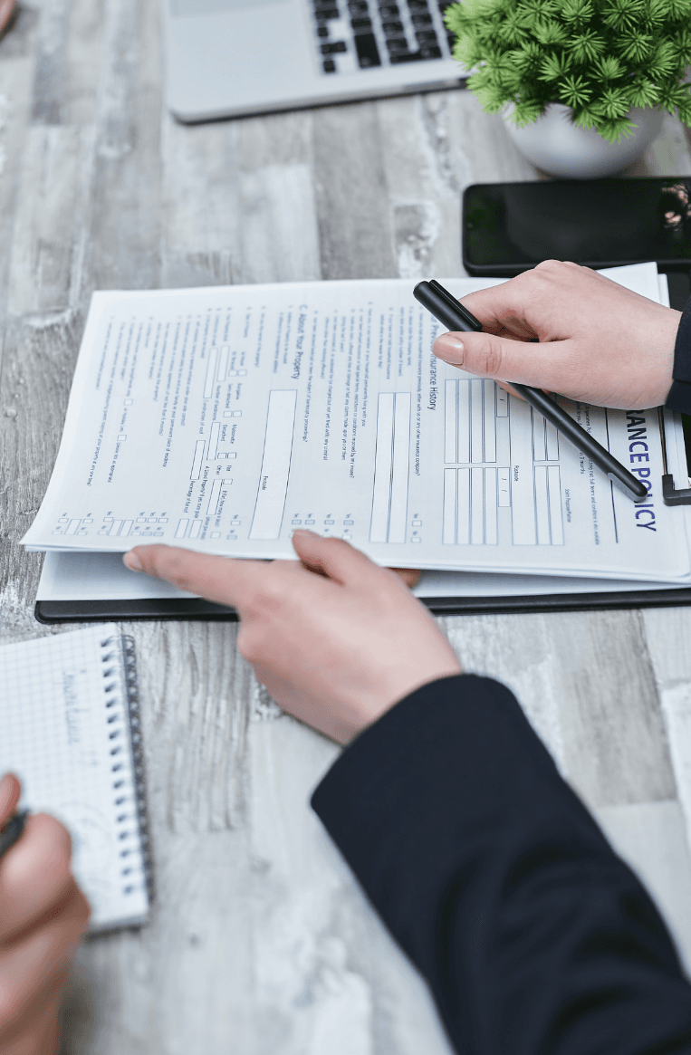 a clipboard filled with paperwork.