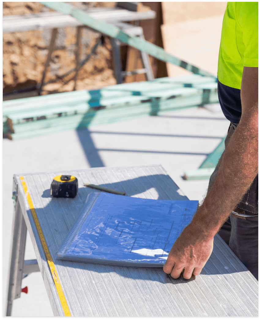 Tradesperson reviewing blueprints